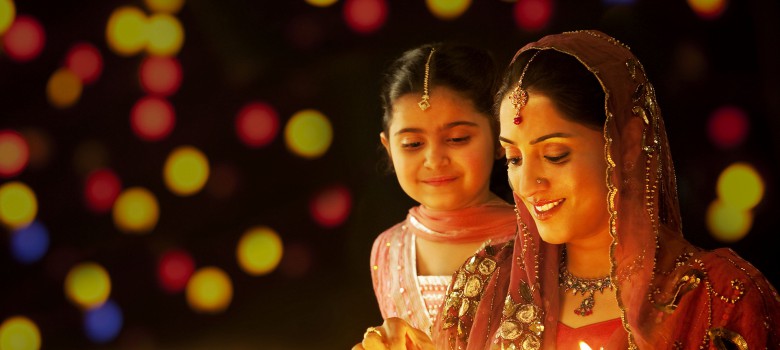 happy-diwali-indian-woman-lighting-diya